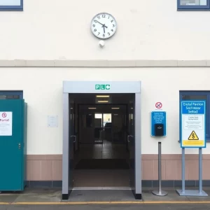 School entrance with metal detector and safety signage.